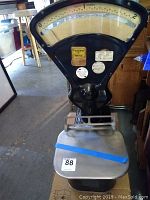 Full front view of scale showing dial, body and platform