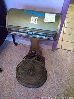 Full front view of floor scale showing cylindrical housing, glass display and platform