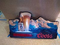 Full view of Coors Light bar sign showing bottle, glass, mountains, and red illuminated panel with Coors logo