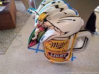 Photo showing the front and side angle of the large three-dimensional Miller Genuine Draft Light beer wall sign, emphasizing the beer glass shape and the surfer figure on top.