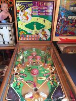 Front view of machine showing playfield under glass and cabinet edges
