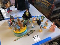 Overview of music box and all miniature Wizard of Oz character figurines on a display table.