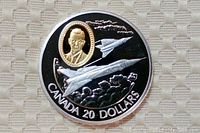 Obverse side of the coin showing gold plated portrait cameo of James A. Chamberlin with the Avro Canada CF-105 Arrow aircraft.