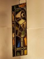 Stained glass panel laid flat showing color and design details.