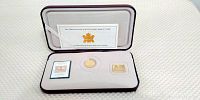 Open presentation box showing the coin, gold plated stamp replica, and modern stamp inside with certificate behind.