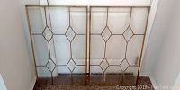 Pair of leaded glass panels side by side showing geometric diamond pattern with frosted lower section