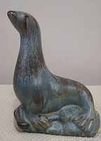 Front view of Blue Mountain Pottery slate seal figurine showing shape, color, and texture.