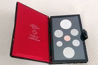 Open Royal Canadian Mint proof coin holder displaying all seven 1977 proof coins including the silver dollar with Throne of the Senate design.