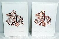 Two art cards side by side, showing Bill Reid's Haida Raven design, signed, with visible embossed artwork in red and black ink.