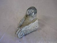 Full side view of the soapstone seal carving showing its shape and texturing.