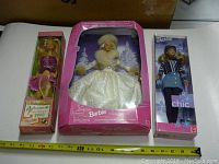 Full view of three Barbies in original boxes, showing size and packaging.