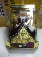 Full view of Barbie doll in original packaging showing gold and dark velvet dress with white faux fur trim