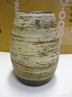 Full view of the vintage ceramic vase showing overall shape and finish with horizontal streak pattern and color variations.