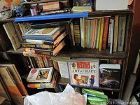 Bookshelves containing assorted books on religion, politics, education, and a children's arts and crafts activity book