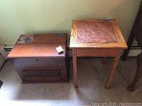 View of oak side table with tile inlay and vintage locking travel chest side by side on carpet, showing condition and design.