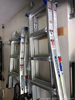 Two ladders hung vertically on wall, showing overall height difference