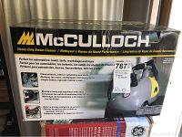 Closed box of the McCullough heavy-duty steam cleaner with branding and usage details visible.