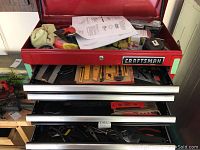 View of the Craftsman tool chest partially open displaying several drawers and various tools inside.