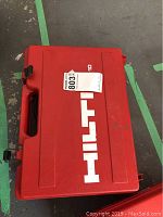 Closed red plastic Hilti carrying case with white Hilti logo