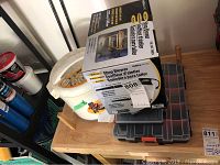 Photo showing Bonaire shop blower box, plastic organizer cases stacked under it, and part of a white bucket visible.