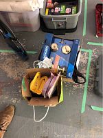 Photo of box containing the Schlage Security Set along with assorted smaller items including yellow shelf brackets and other accessories.