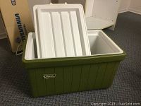 Green Coleman cooler with removable lid, shown from a slight angle to view opening and exterior.
