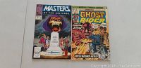 Photo of two Marvel comic books: Masters of the Universe #12 on left and Ghost Rider #9 on right, showing front cover artwork.