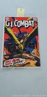 Front cover of vintage G.I. Combat comic book showing soldier with tank and explosions, text 'Stay Alive Until Dark!'
