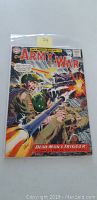 Front cover of the comic showing a World War II battle scene with soldiers, gunfire, and explosions. Title 'Our Army at War' prominently displayed at the top with price 12 cents.