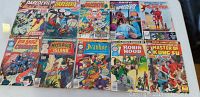 Front view of 10 vintage Marvel comic books including Daredevil, Iron Man, Master of Kung Fu, Mysterious Island, Ivanhoe, and Robin Hood with visible damage and wear.
