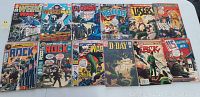 Photo showing fronts of 12 DC war comic books including Weird War Tales #1, G.I. Combat, Our Fighting Forces, Our Army at War, Fighting Men. Some covers torn or missing, all show wear consistent with age and use.