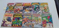 Front view of 10 vintage DC comic books featuring Kamandi #1, Aquaman, Challengers of the Unknown, Strange Adventures, and Metamorpho titles showing visible wear and damage
