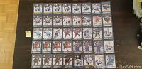 Photo showing 40 hockey cards neatly arranged in 4 rows, each card sleeved, featuring players from the Upper Deck 15/16 Young Gun rookie hockey card series with some duplicates noted.