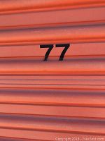 Storage unit door marked number 77