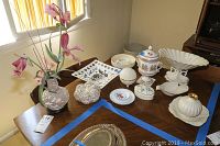 Photo showing the Lenox porcelain centerpiece vase, ashtray, trinket dishes, fish dish, decorative orb and other dishes on a dining table with window light.