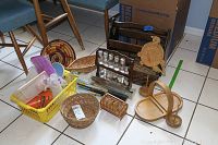 Photo showing all items including wicker baskets, spice rack, wooden magazine rack, kitchen utensils in yellow basket