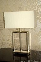 Front view showing clear leaded glass panels framed in chrome with rectangular fabric shade