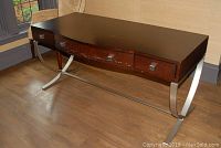Front angle view of the Century Furniture executive desk showing top, drawers, and metal legs
