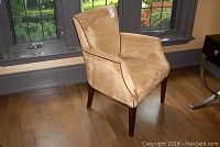 Front right angled view of tan microsuede upholstered arm chair