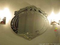 Full frontal view of the oval mirror showing overall shape and etched design