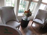 Two occasional chairs side by side near window with small side table between