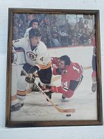 Framed color photograph of Bobby Orr in Boston Bruins uniform playing hockey, signed by Bobby Orr.