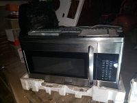 Over-the-range microwave oven in clean condition, stainless steel, showing front and control panel.