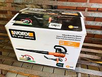 Original boxed Worx WG508 blower on wood bench showing product branding, performance numbers and warranty.