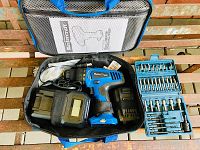 Overall view of cordless drill kit inside soft carrying bag showing drill, charger, and drill bits