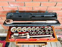 Photo of 3/4 inch drive socket set showing sockets neatly arranged in a red metal case with the large ratchet wrench in a separate black plastic case above.