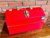Closed red SPG International steel toolbox showing exterior condition and brand badge