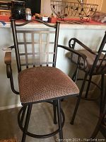 Full view of a barstool showing cushioned seat, metal frame with armrests and backrest