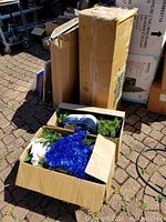 Several cardboard boxes containing the artificial Algonquin Christmas tree and decorations.