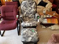 Photo showing the glider rocker chair with floral patterned upholstery alongside matching ottoman. Chair wooden frame visible.